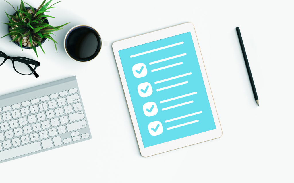 Checklist app on a tablet sitting on a desk