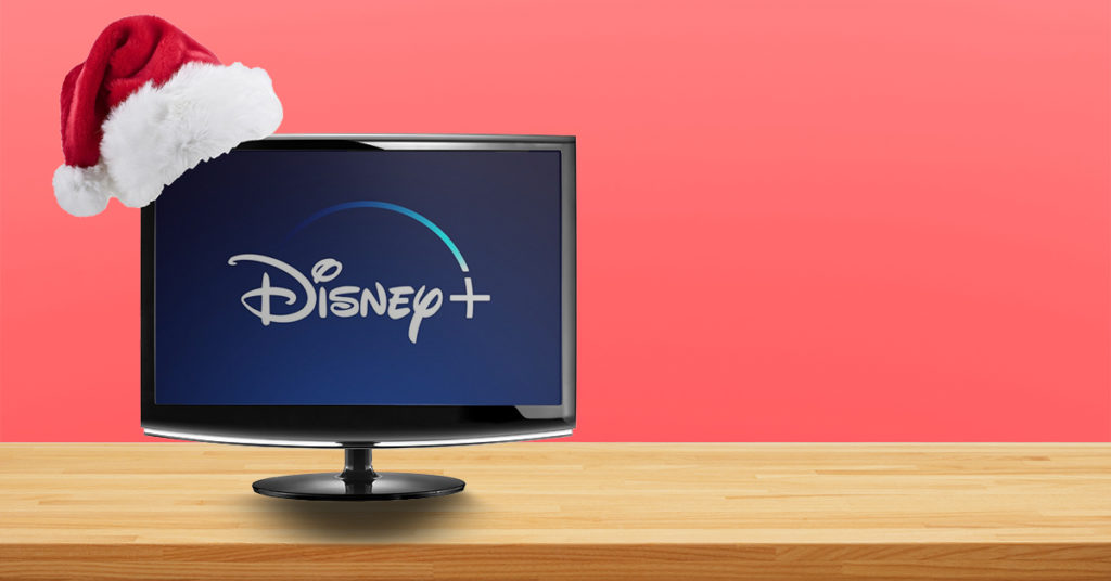 Santa hat sitting on top of a computer monitor with Disney plus on screen